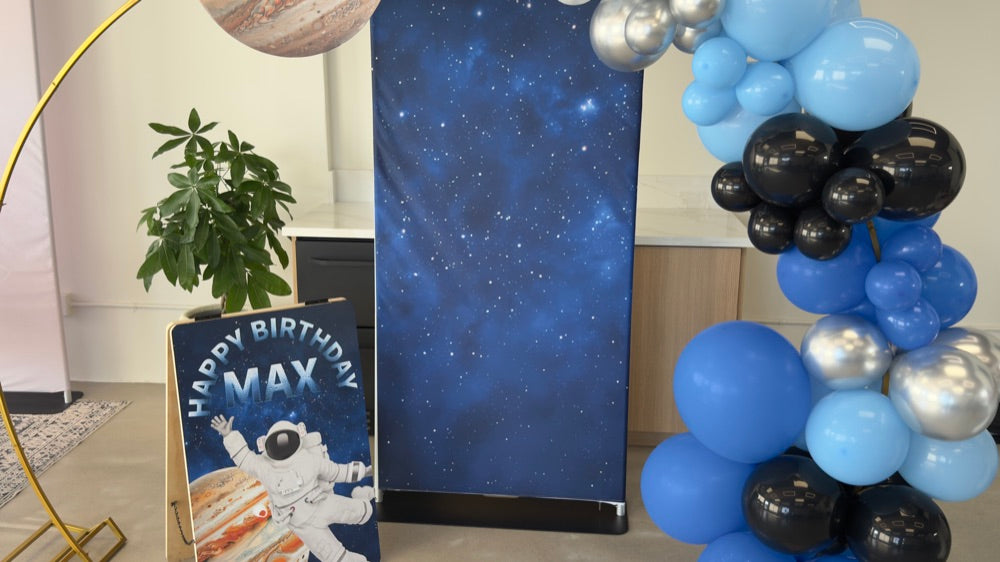 Real client install — pillowcase fabric backdrop printed by Promo & Grow at a space-themed birthday